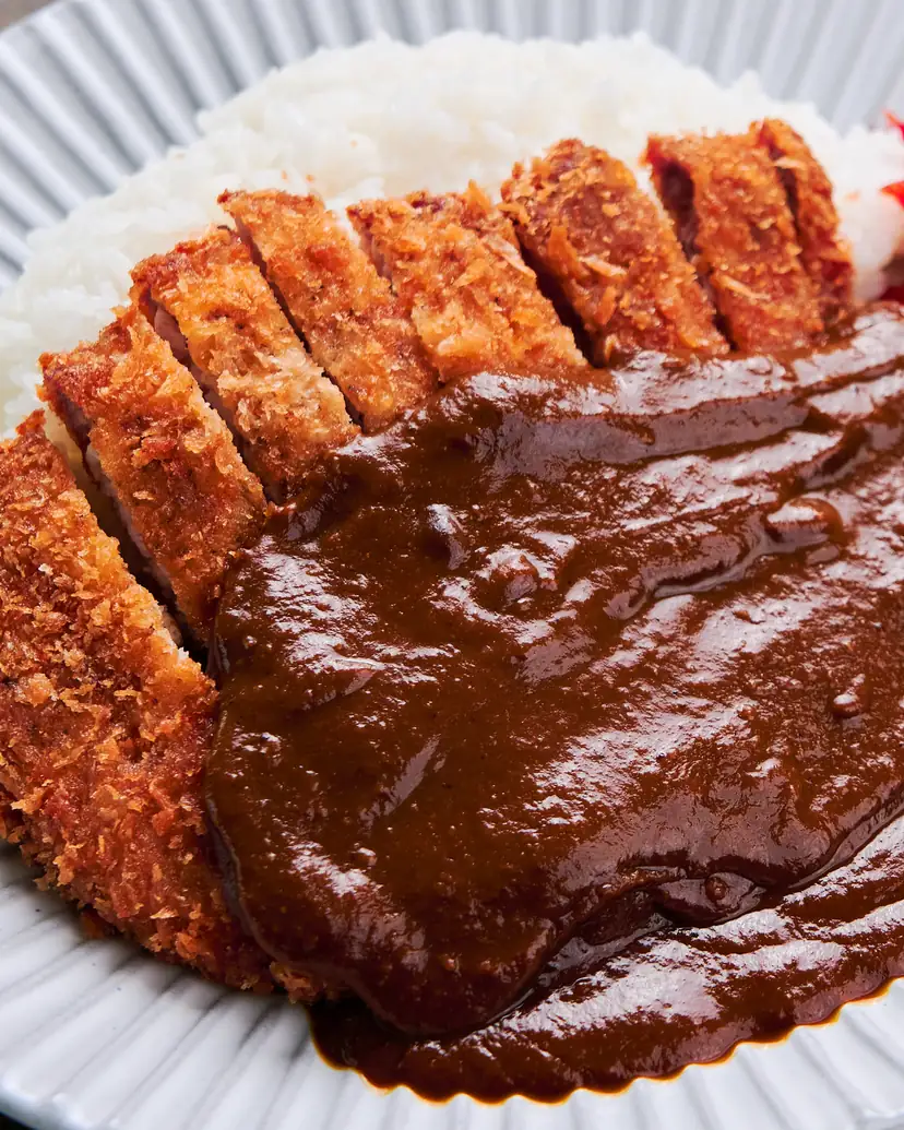 A sliced crisp pork cutlet with rich brown curry sauce and rice
