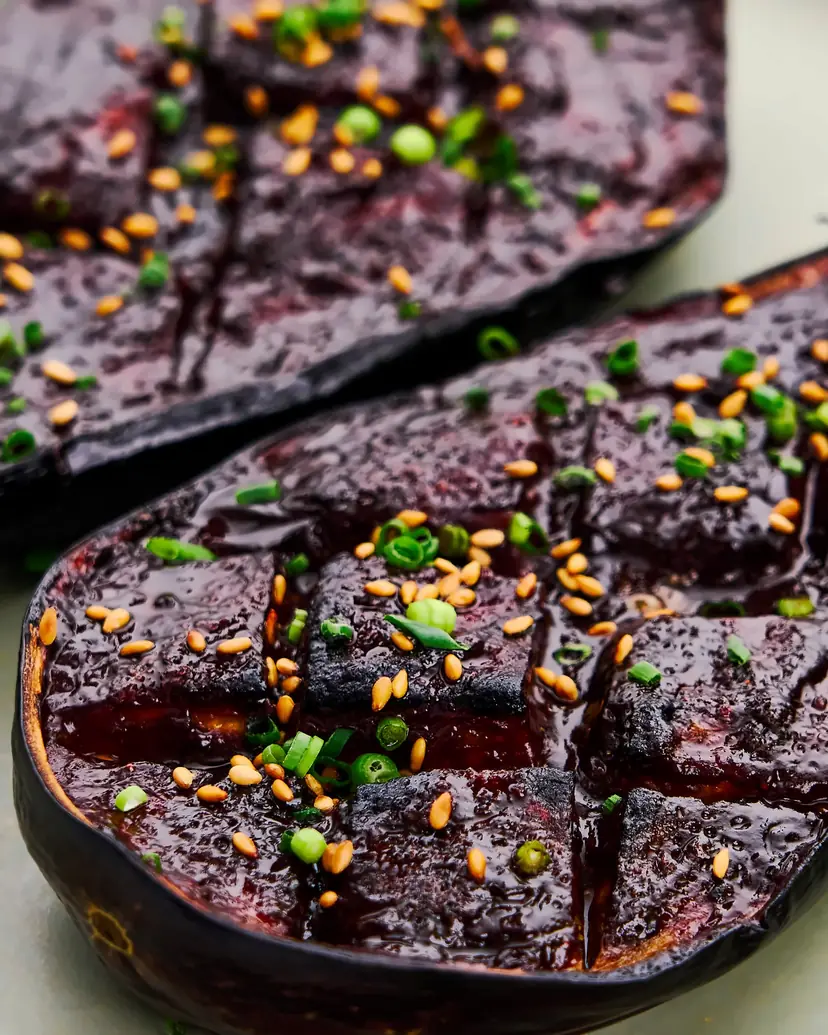 Halved eggplant glazed with dark miso, topped with sesame seeds and green onion