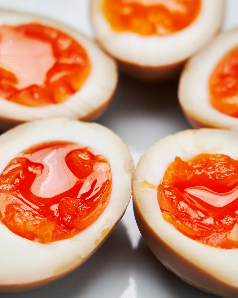 Halved soy-marinated eggs with jammy orange yolks