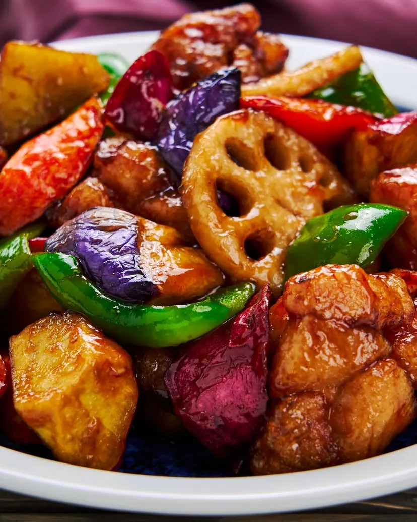 Fried chicken with lotus root, eggplant, sweet potato and peppers in a glossy sweet and sour glaze