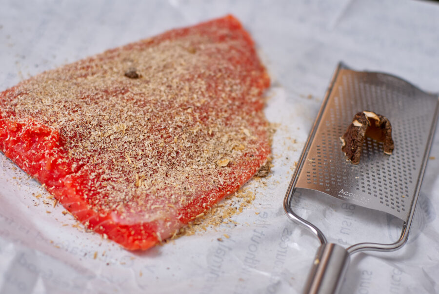 Grated dried shiitake on a filet of salmon.