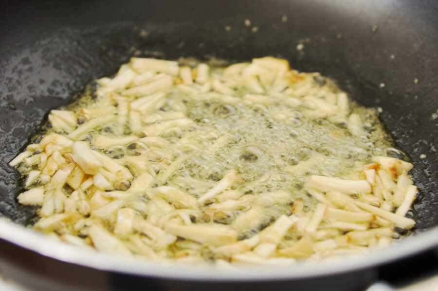 Sauteing matsutake mushroom stems for risotto.