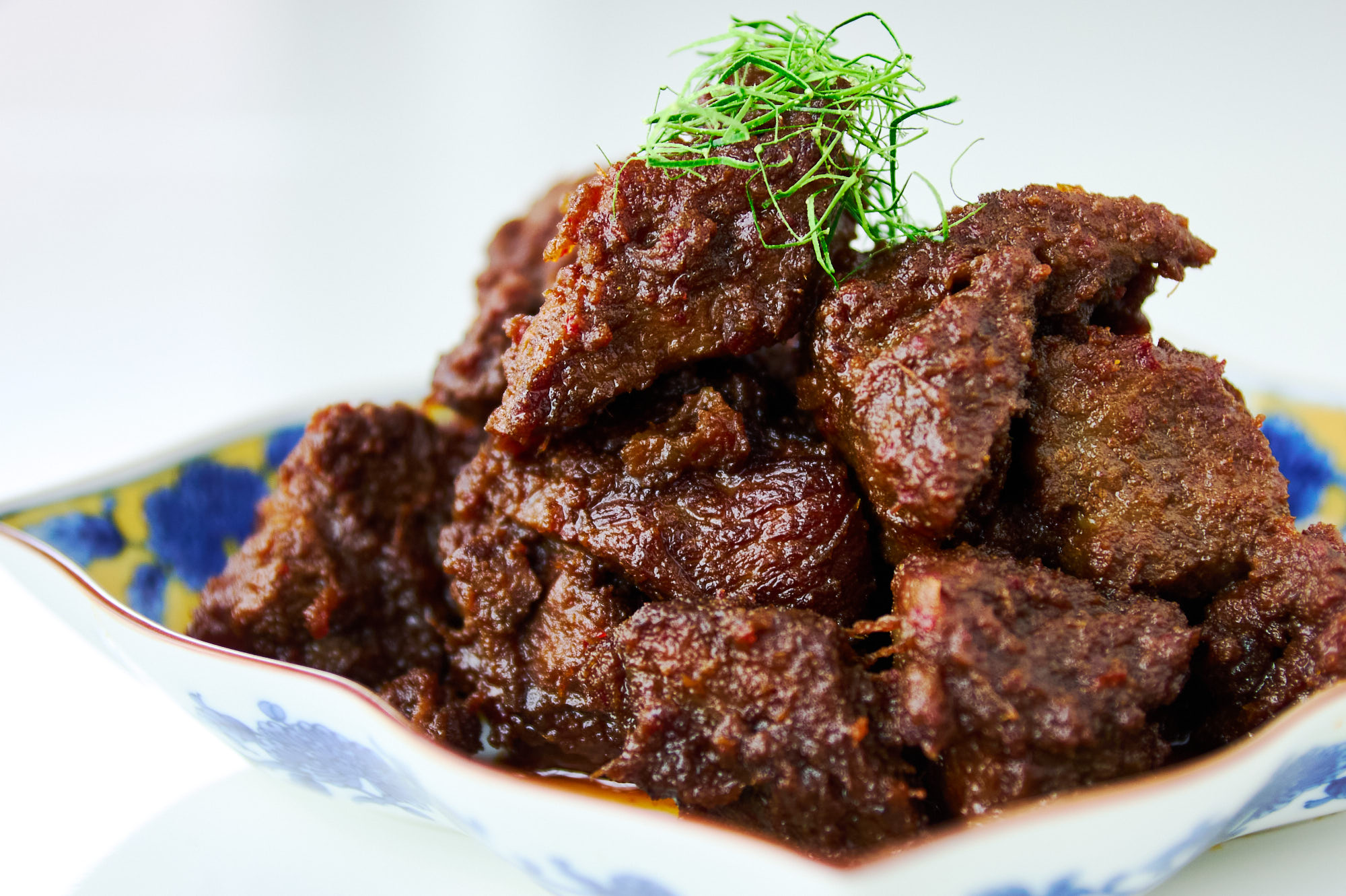 Fall-apart beef rendang wrapped in a glossy caramelized coating of spices and aromatics gives each tender piece layers of flavor.