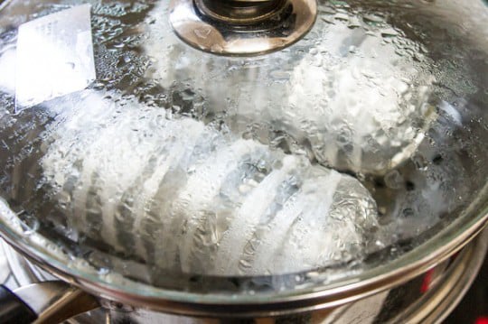 Marinated chicken is steamed in foil.