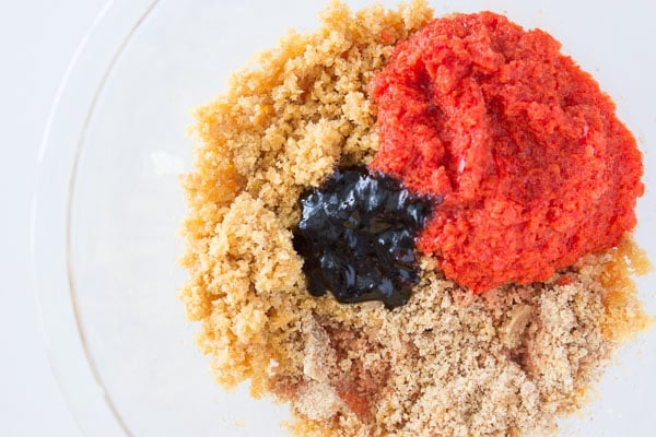 Bread crumbs, peppers, and pepper paste in a bowl.