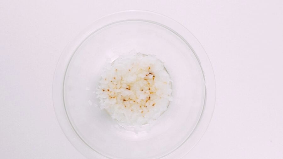Microwaved onions in a glass bowl for hamburger patty.
