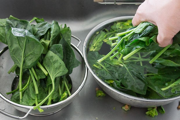 Thoroughly washing the spinach.