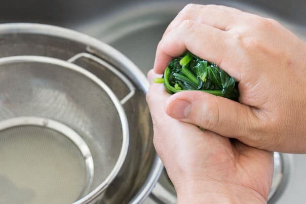 Squeezing water out of spinach.