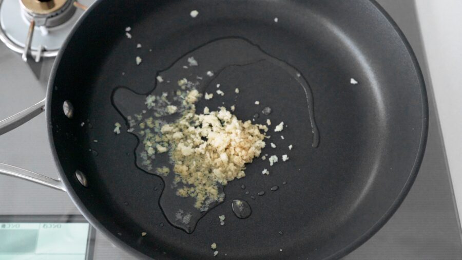 Ginger and garlic sautéing in oil for making fried noodles.