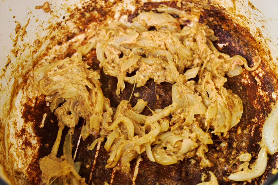Sweet shallots mingle with caramelized mustard fond on the pot’s bottom, forming a richly browned base for the sauce to come.