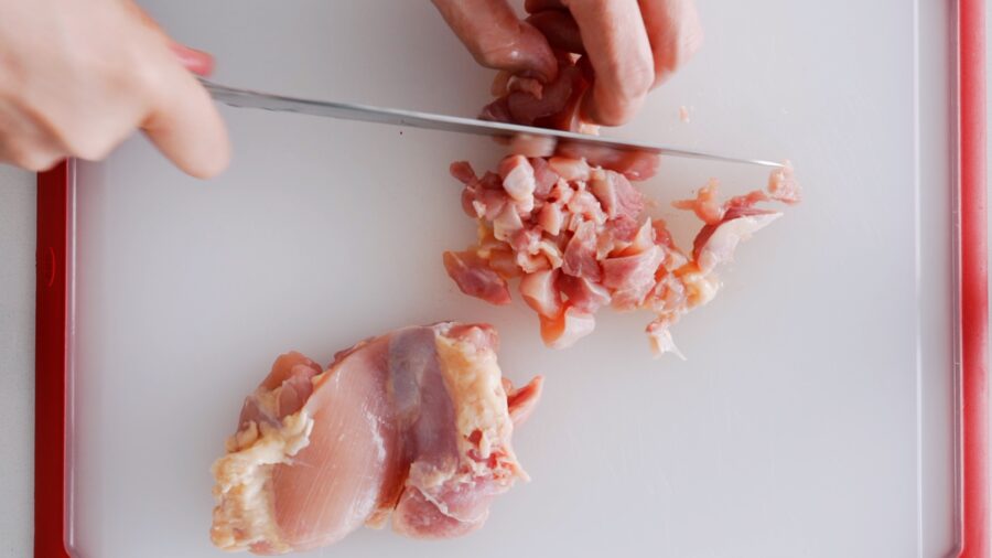 Mincing chicken for Pad Kraprow Gai