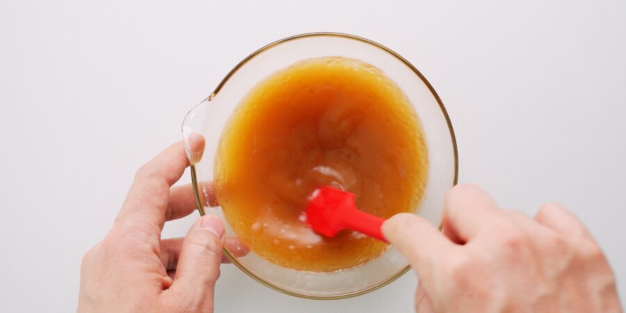 Mixing sauce for Chop Suey in a glass bowl.