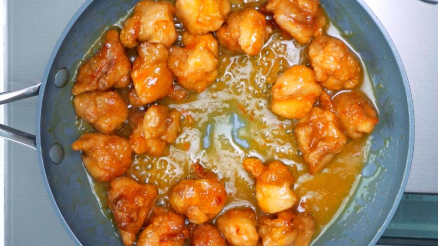 Orange chicken in a frying pan.