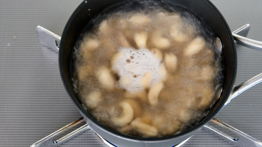 Boil the raw cashew nuts to soften them up.
