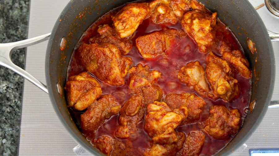 You can skim some of the oil off the rendang as the chicken cooks down.