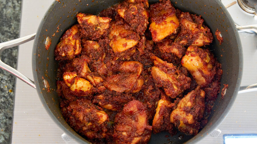 Add the kerisik to the chicken rendang and fry until there is no sauce left.