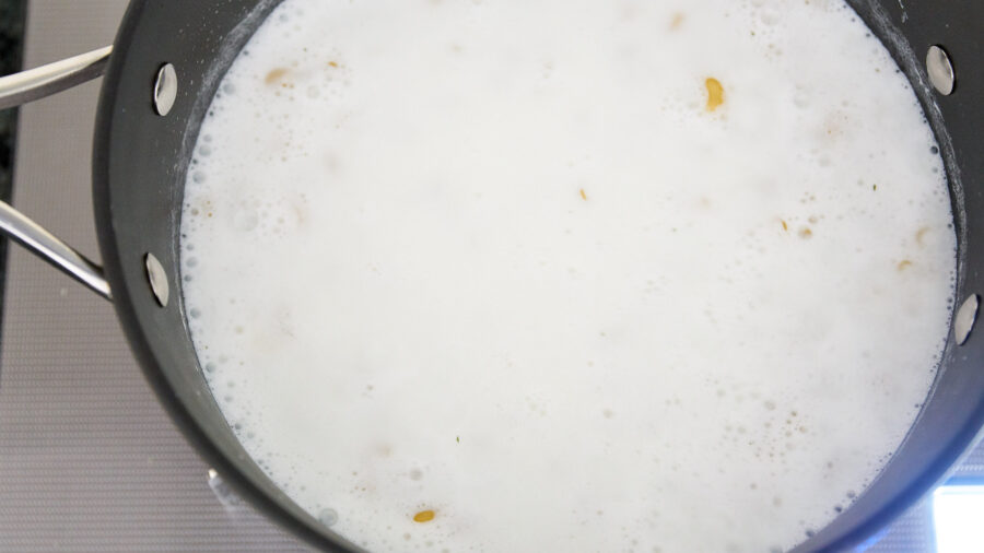 Boil the macaroni in milk just the right amount of water to save time.