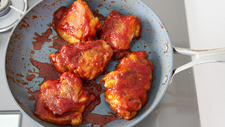 Chicken thigh pieces covered in honey lemon and tomato sauce.