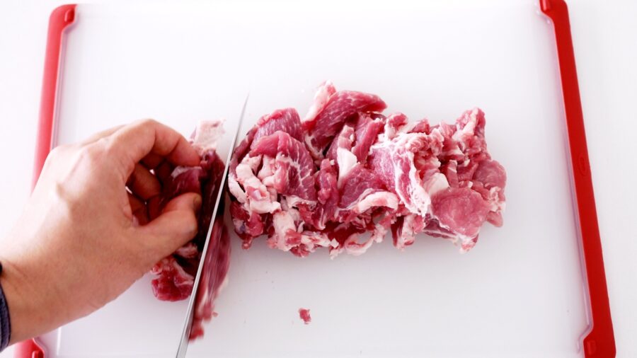 Slicing pork shoulder thinly for making Japanese Ginger Pork.