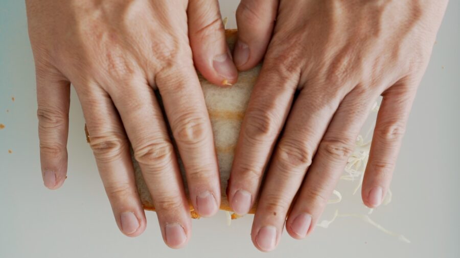 Use your hands to press on the Katsu Sandwich to help the bread conform to the cutlet.