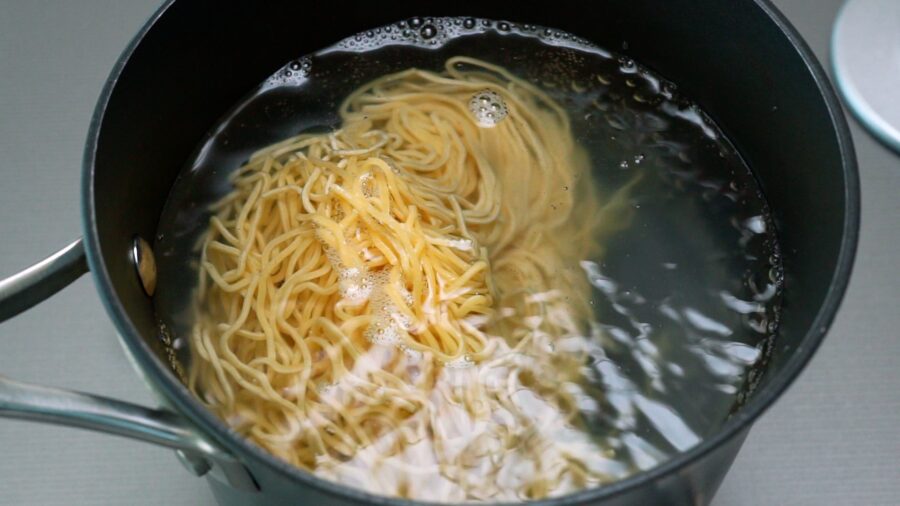 Boiling ramen noodles for making chilled ramen salad.