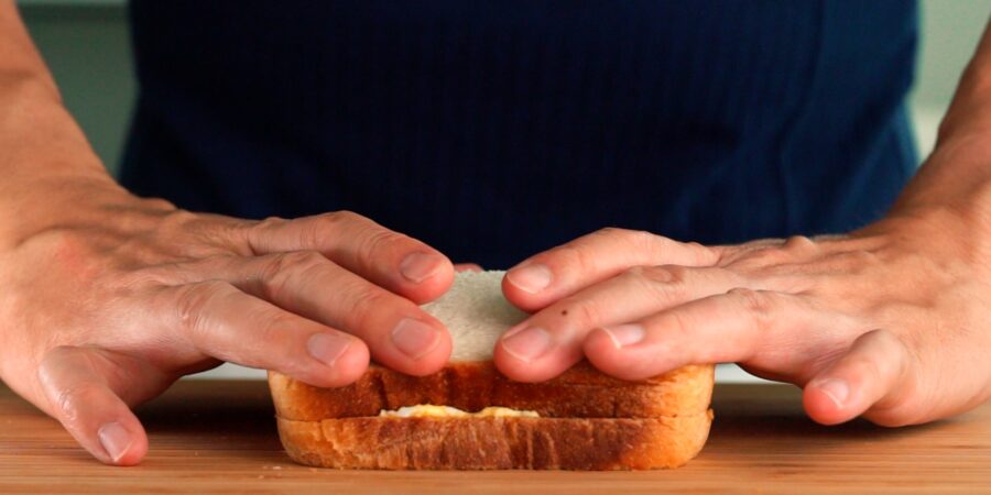 Smashing a Japanese style egg sandwich together.