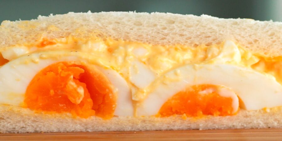 Japanese style egg sandwich with halved medium boiled eggs and egg salad.