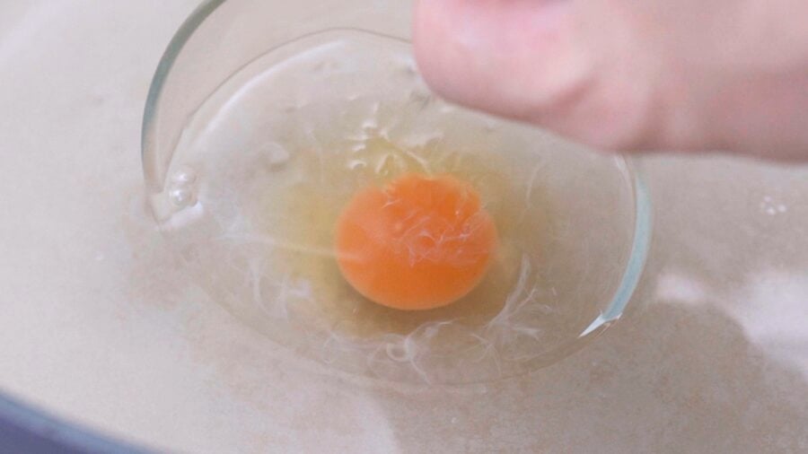 Gently lower the bowls directly into the water and tip the egg out.