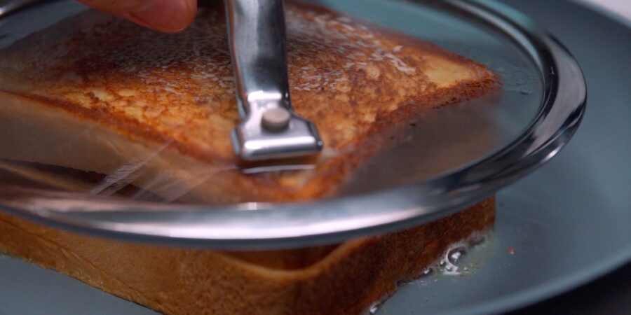 Grilled curry bread under a glass drop lid.