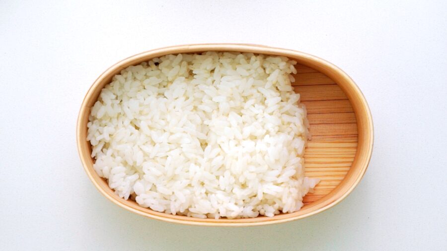 Rice packed into a wooden bento box.