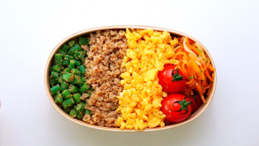 Chicken Soboro, Egg Soboro, and Green Bean Goma-ae packed into a wooden bento box.