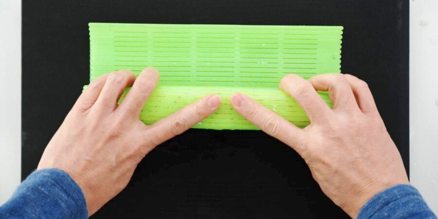 Compressing sushi roll with mat.