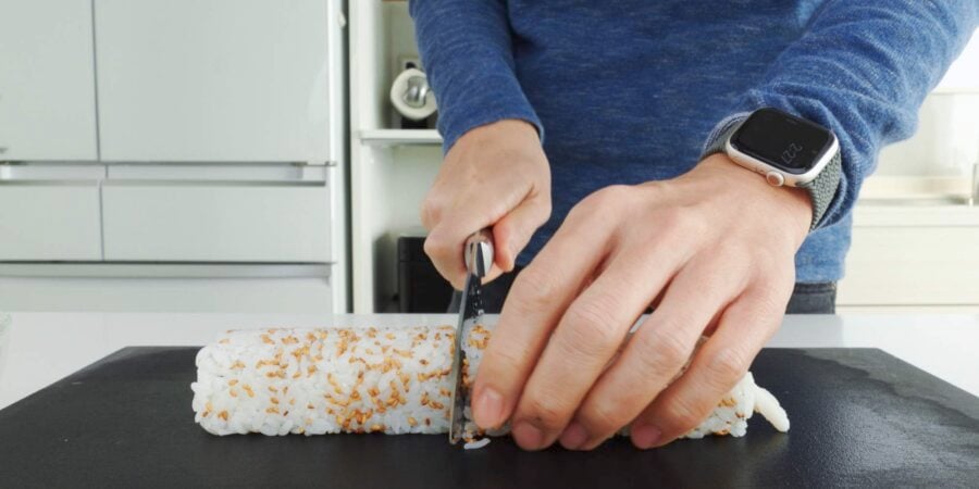 Slicing California Sushi Roll.