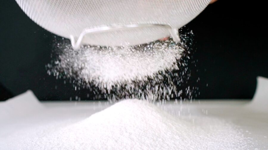 Sifting flour for making sponge cake.
