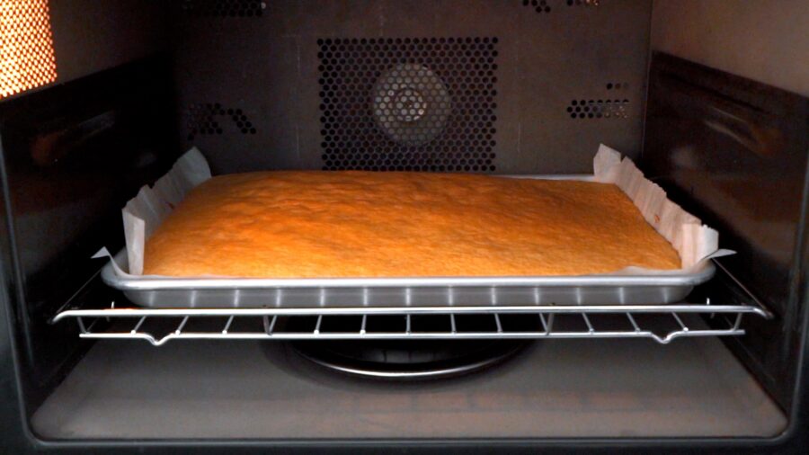 Baking the cake in the oven.