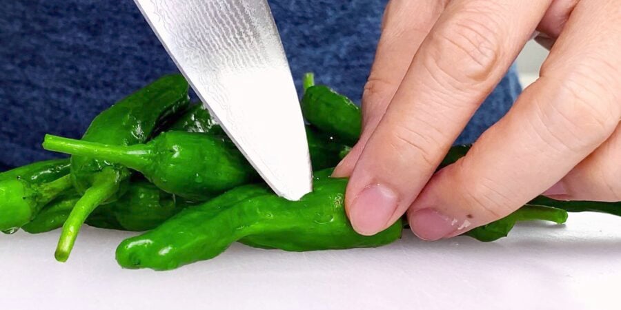 Poking holes in peppers to keep them from popping.