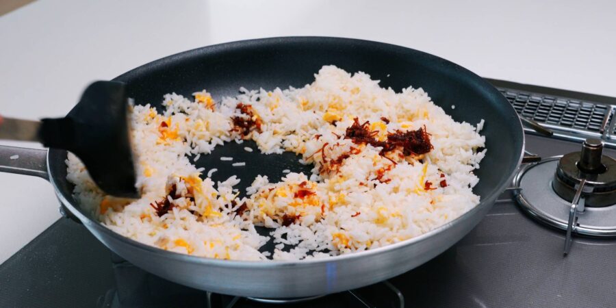 Egg fried rice in a frying pan.