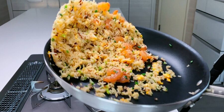 Tossing Shrimp Fried Rice in a frying pan.