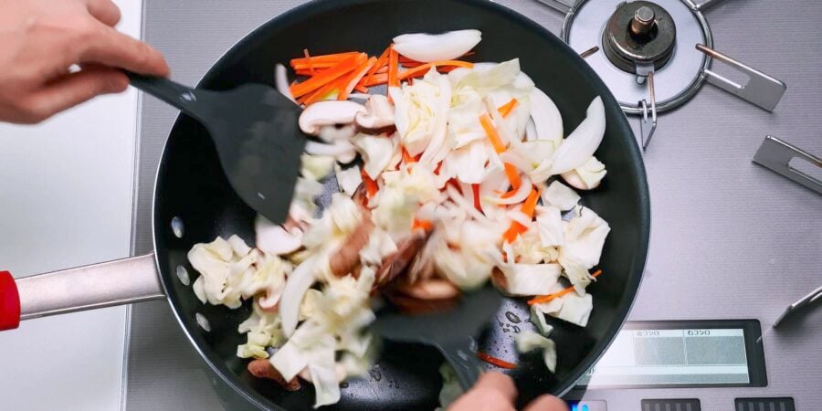 Stir-frying cabbage, carrots, onions and shiitake mushrooms for Yaki Udon.