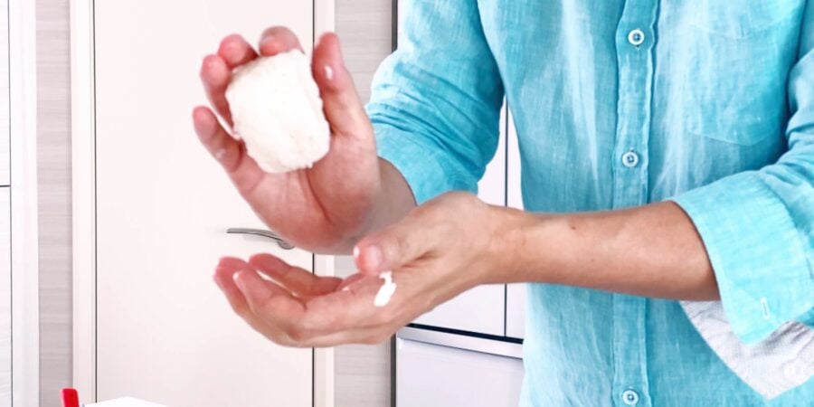 Toss the ball to roll it onto another side and continue shaping it until it's a perfect triangle.