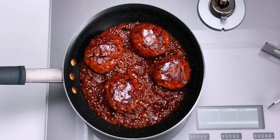 Glazing Hamburg Steak with Teriyaki sauce.