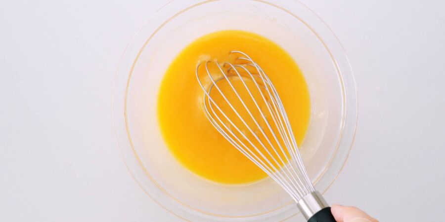 Egg mixed into melted butter and chocolate mixture for brownie.