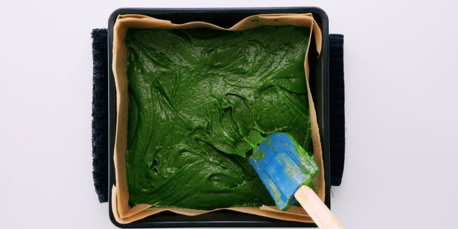 Matcha brownie batter in pan.