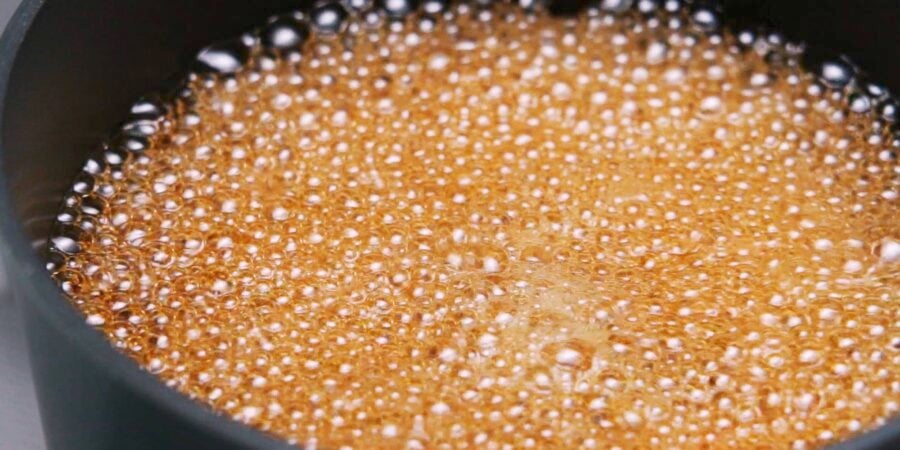 Boiling ramen egg marinade in a pot.