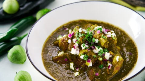 Fork-tender chunks of pork shoulder braised in a tangy sauce made from char-roasted green chiles and tomatillos. Garnished with queso fresco, cilantro and red onions.