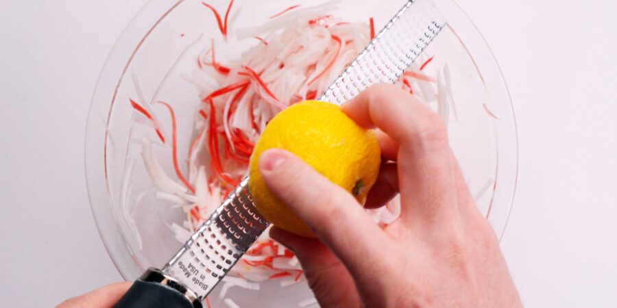 Grating yuzu zest onto Kohaku Namasu.