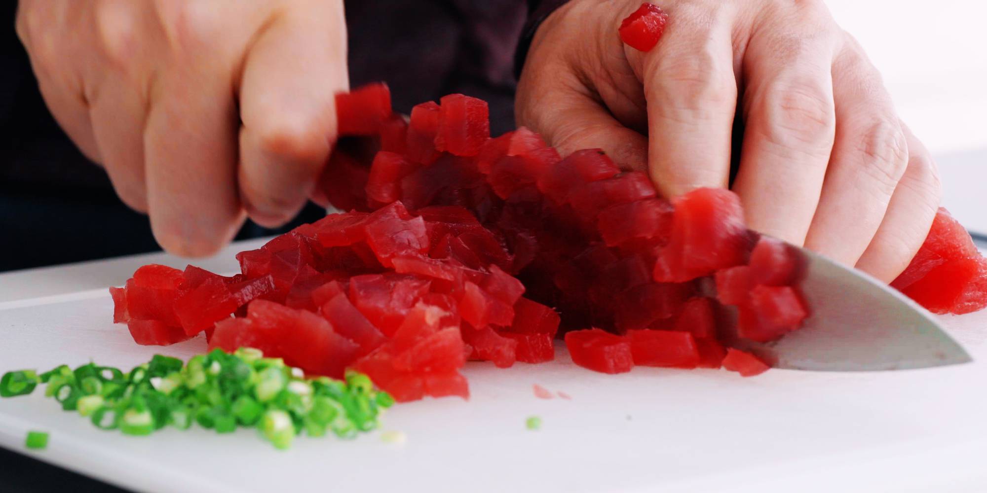 Mincing tuna for spicy tuna rolls