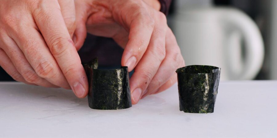 Wrapping sushi rice with nori for Gunkan roll.