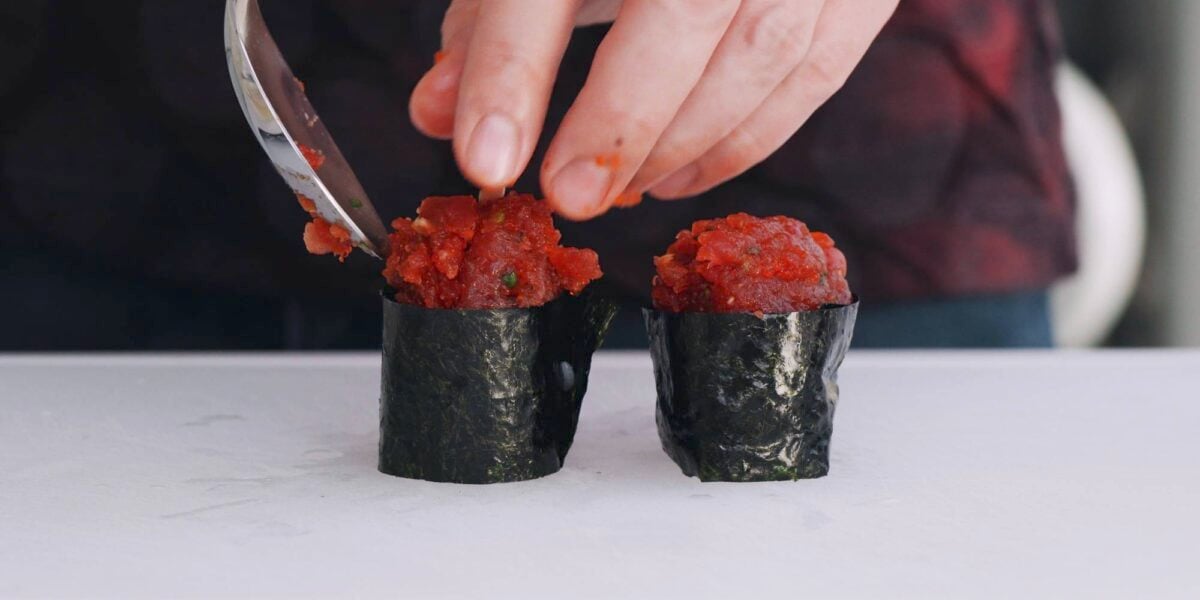 Adding spicy tuna to gunkan roll.