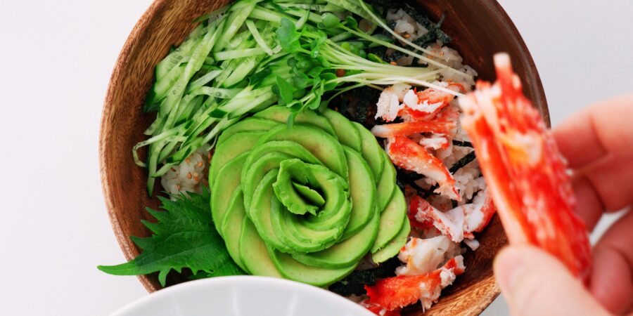 Avocado and crab on top of sushi rice.